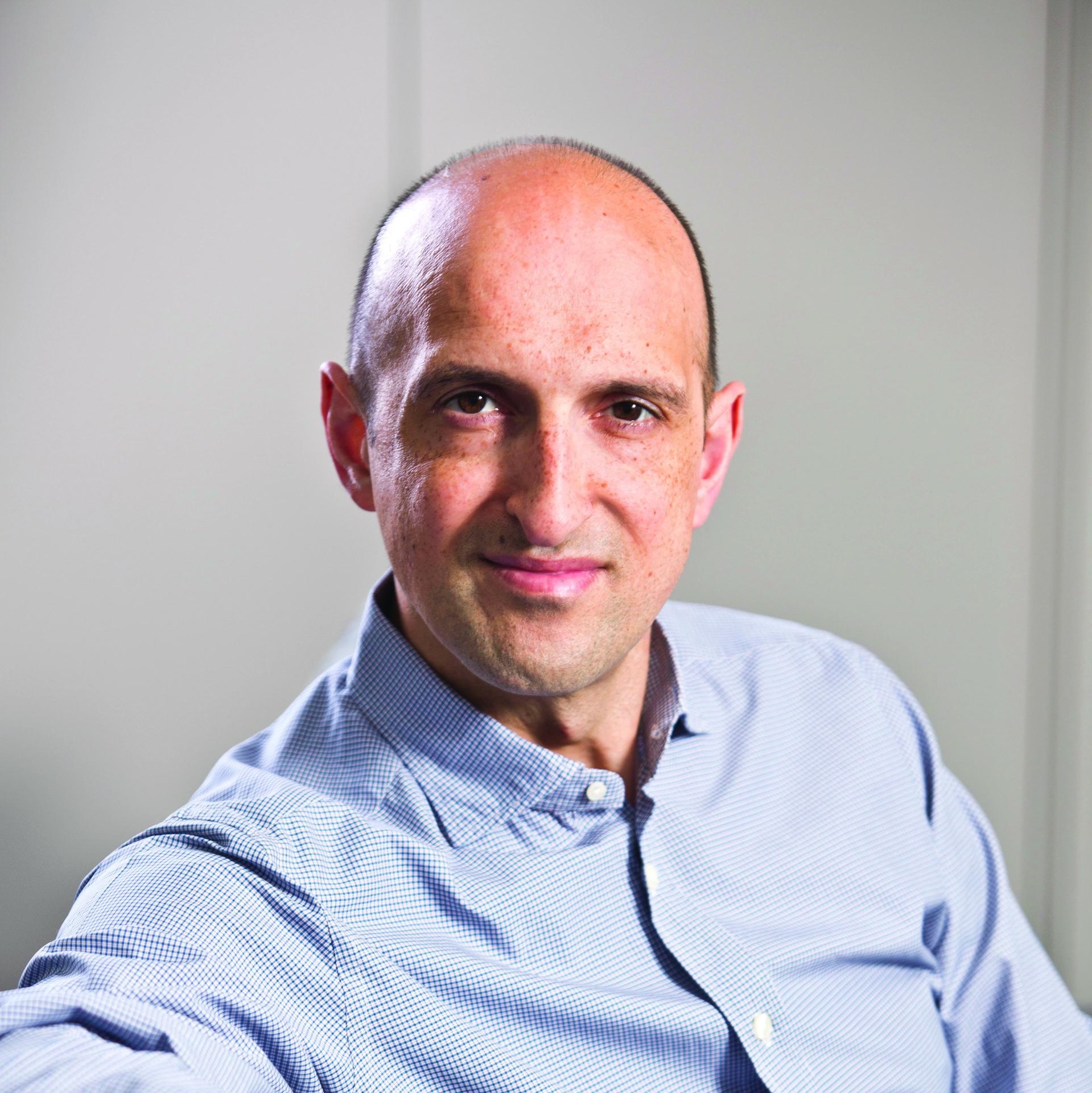A photo of Matthew Syed in a blue shirt