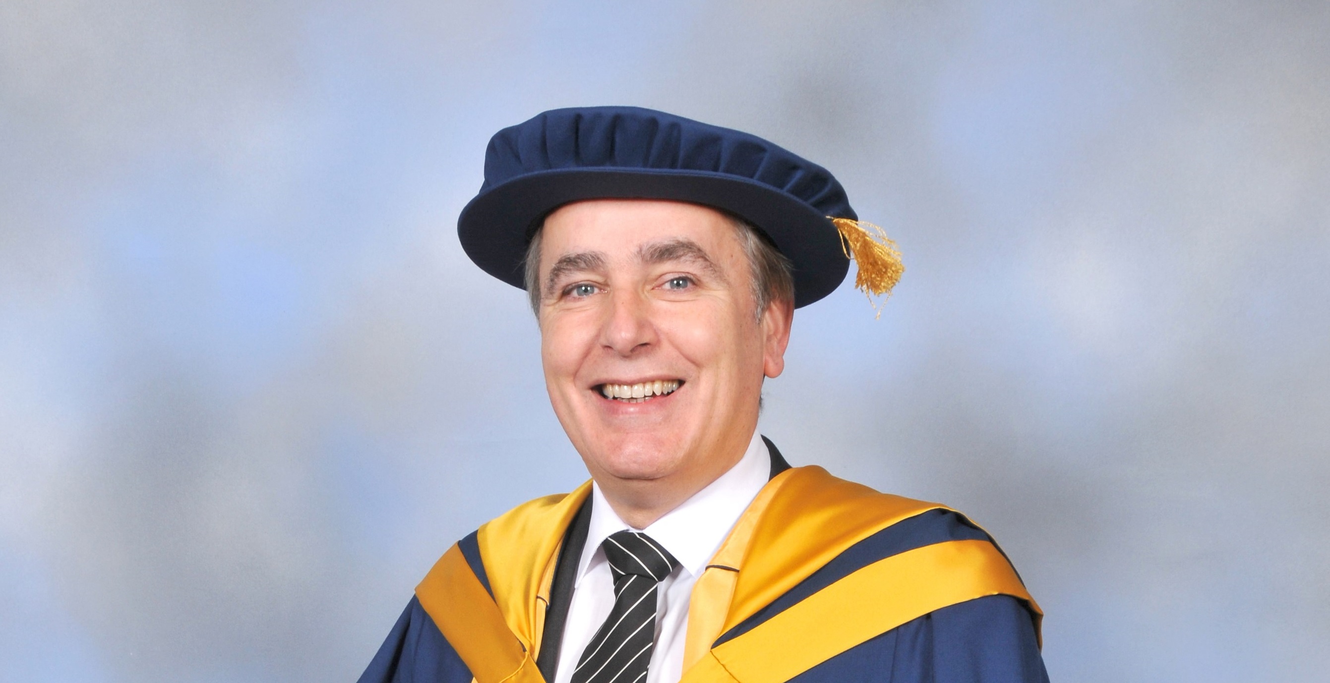 A photo of Stuart Wall in graduation outfit