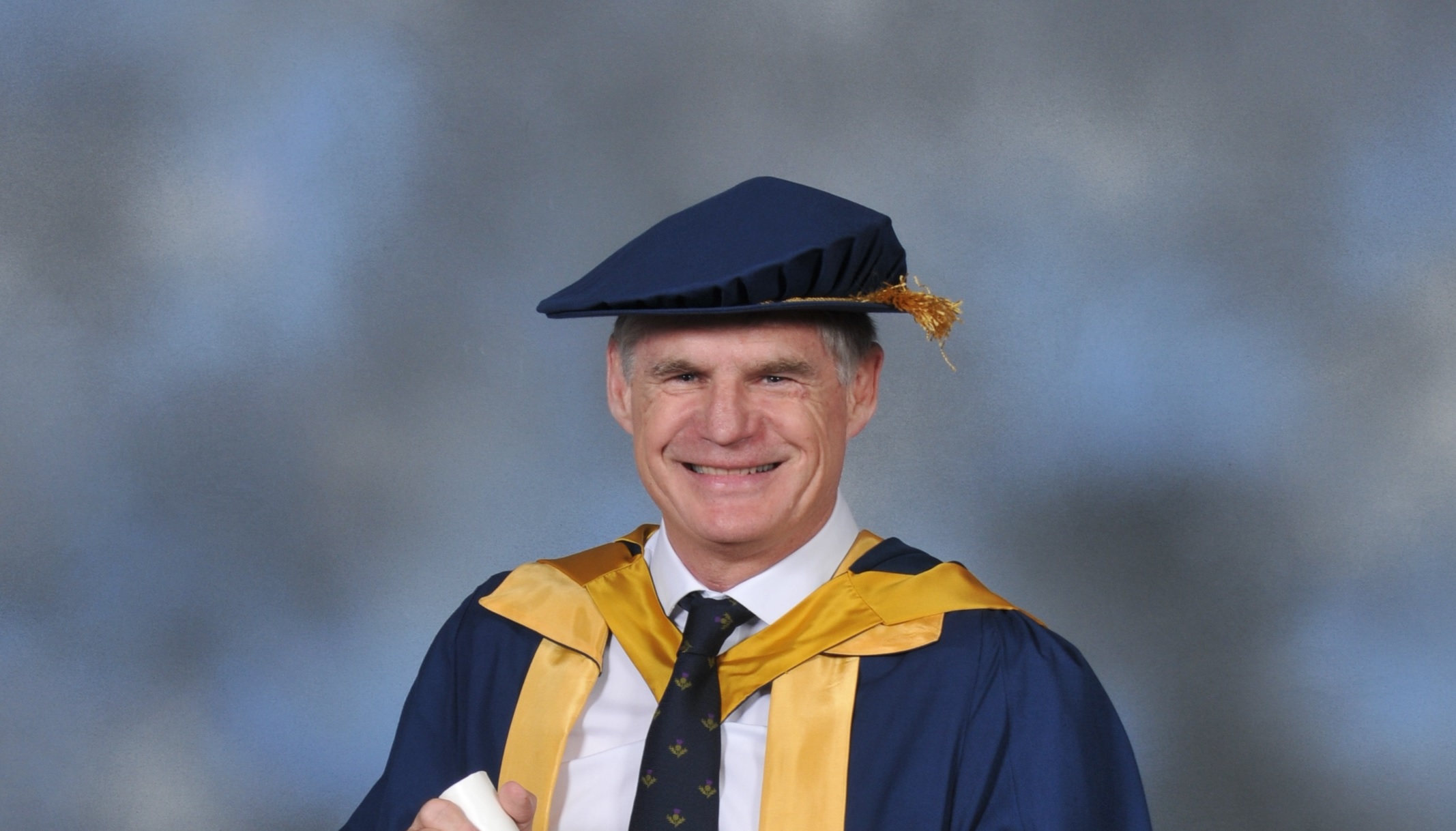 A photo of John Beattie in his graduation outfit