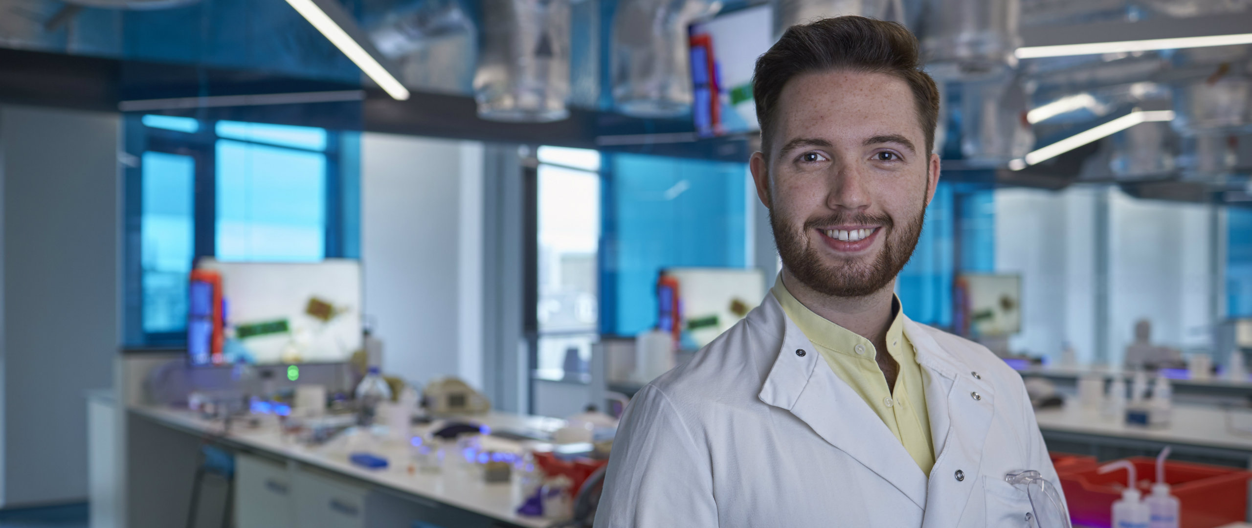 Smiling male standing in a science laboratory