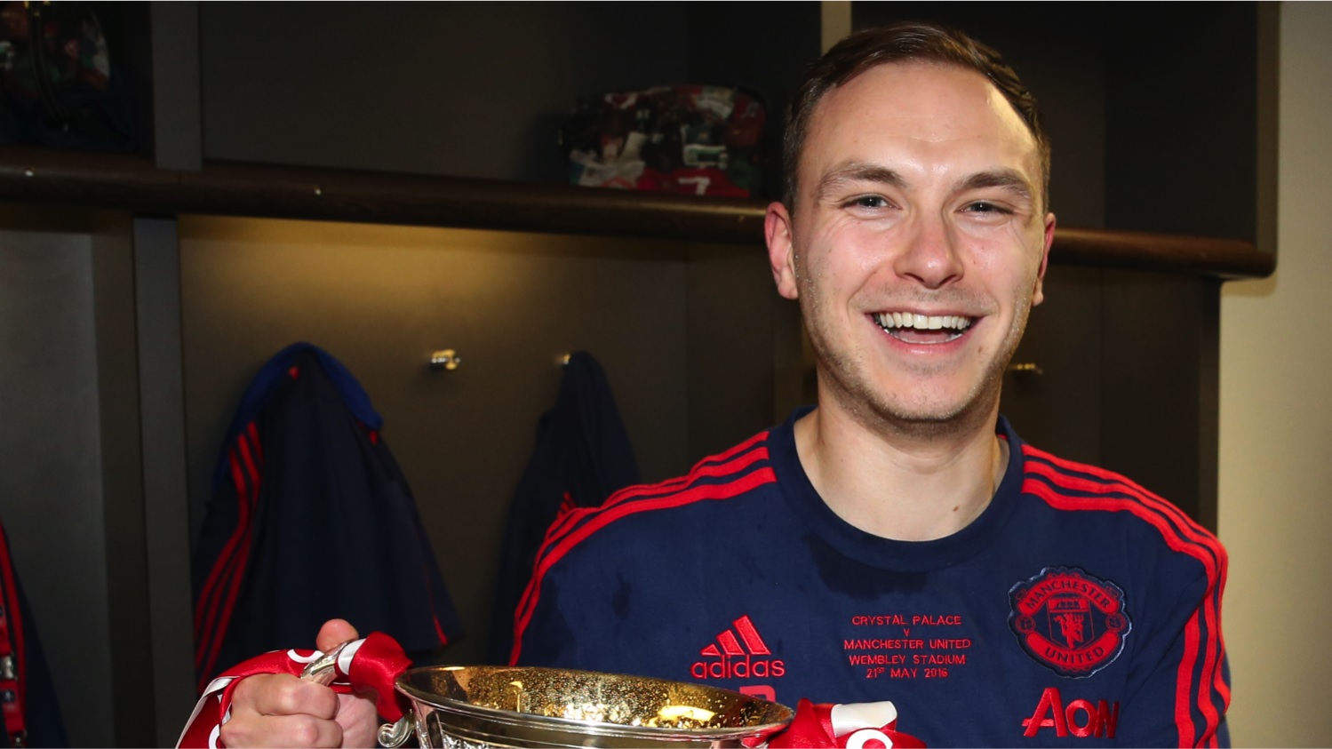 A photo of Paul Brand in Manchester United kit holding a trophy
