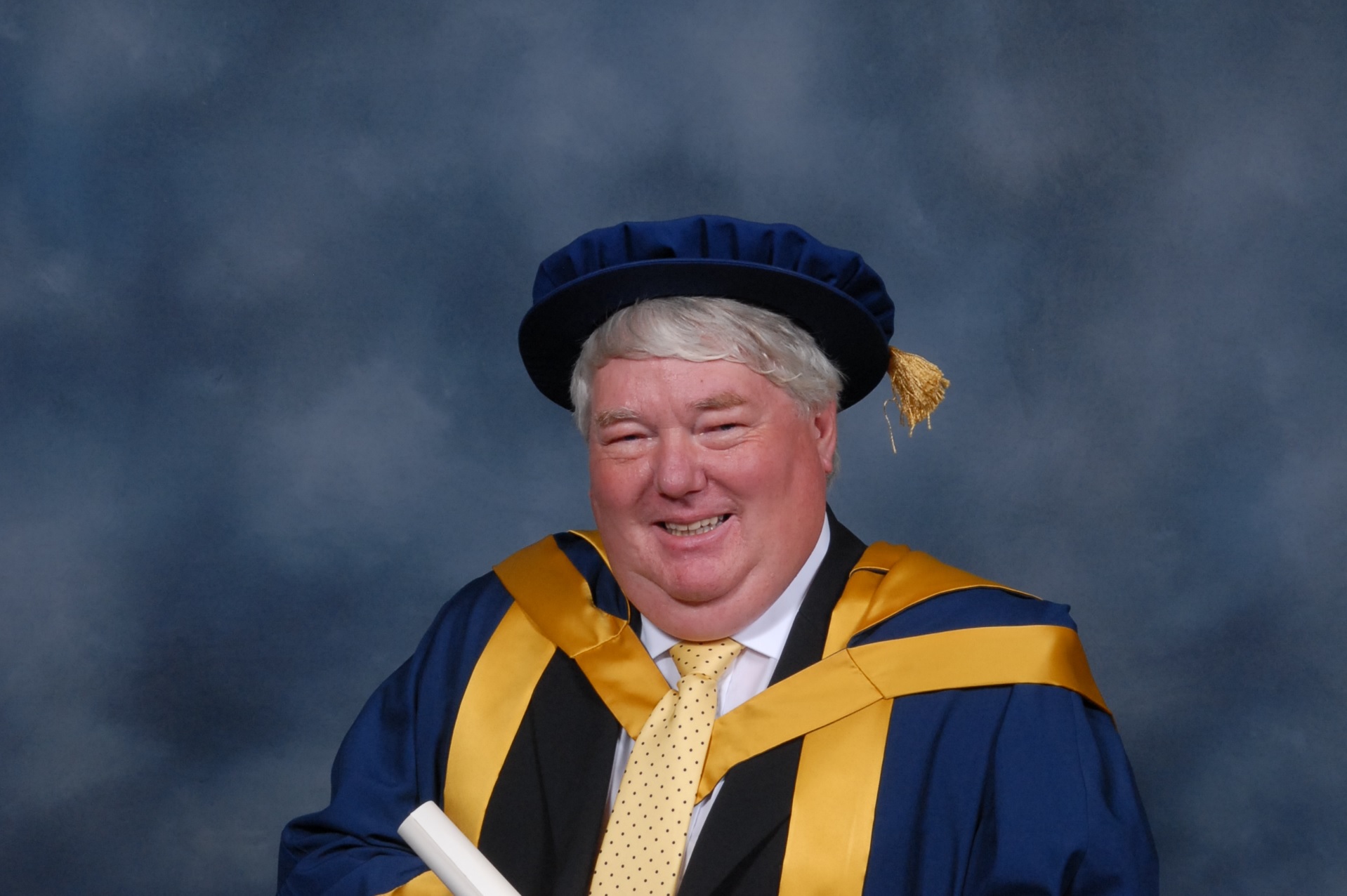 A photo of BBC Political Editor Brian Taylor in his graduation outfit