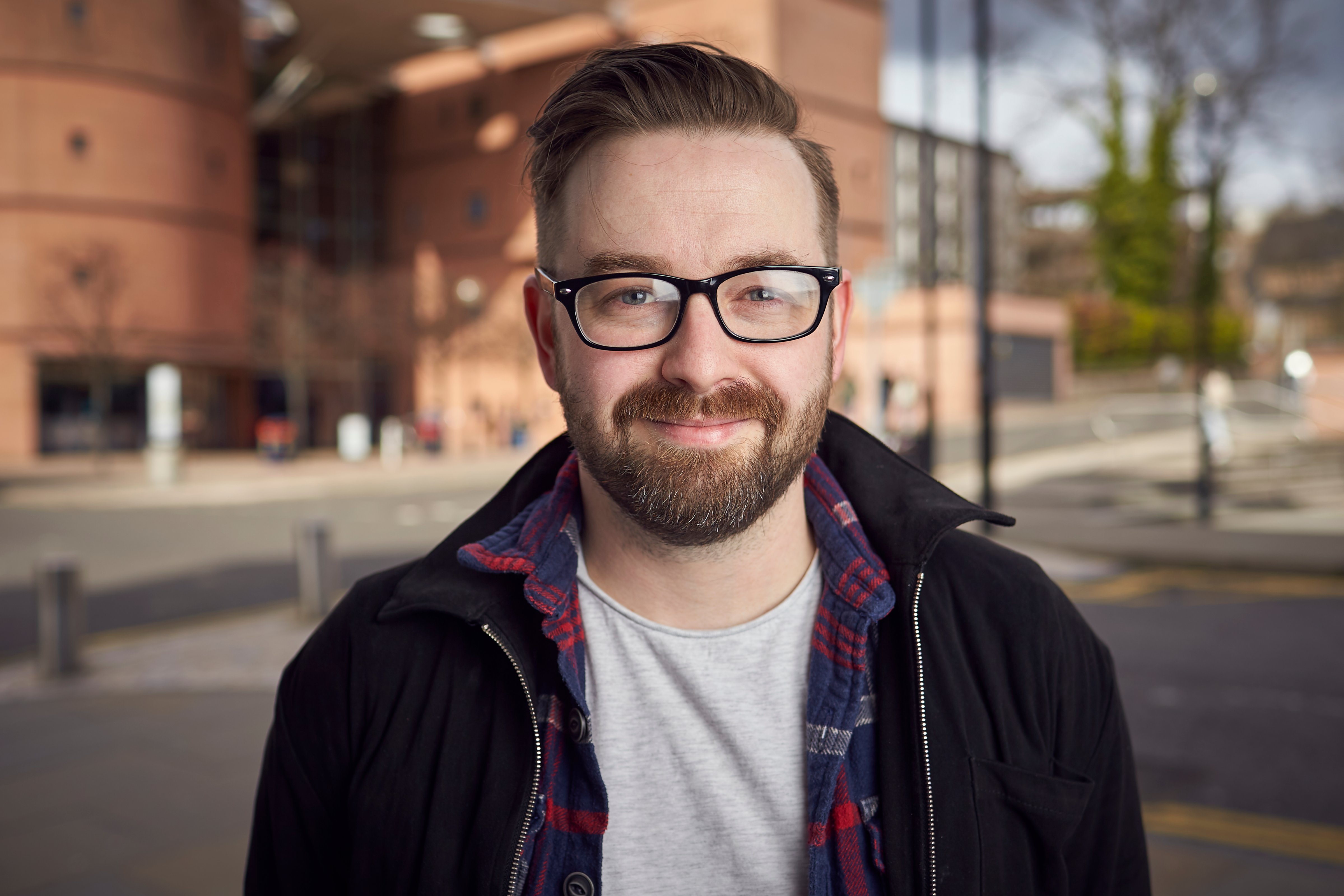 A photo of Dr Neil Kirk in front of Abertay's library