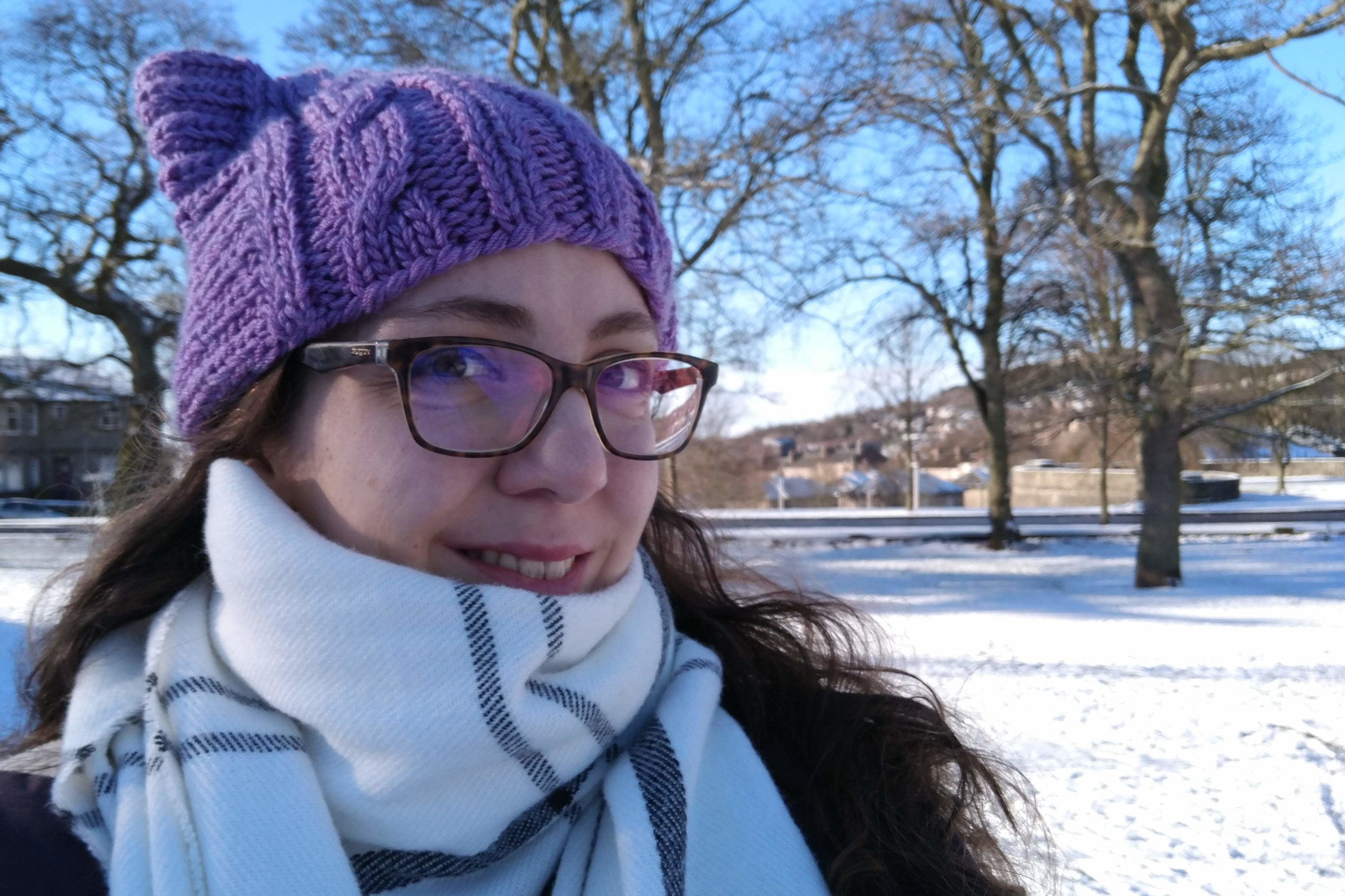 Picture of Maria smiling, in the background is snow covered ground
