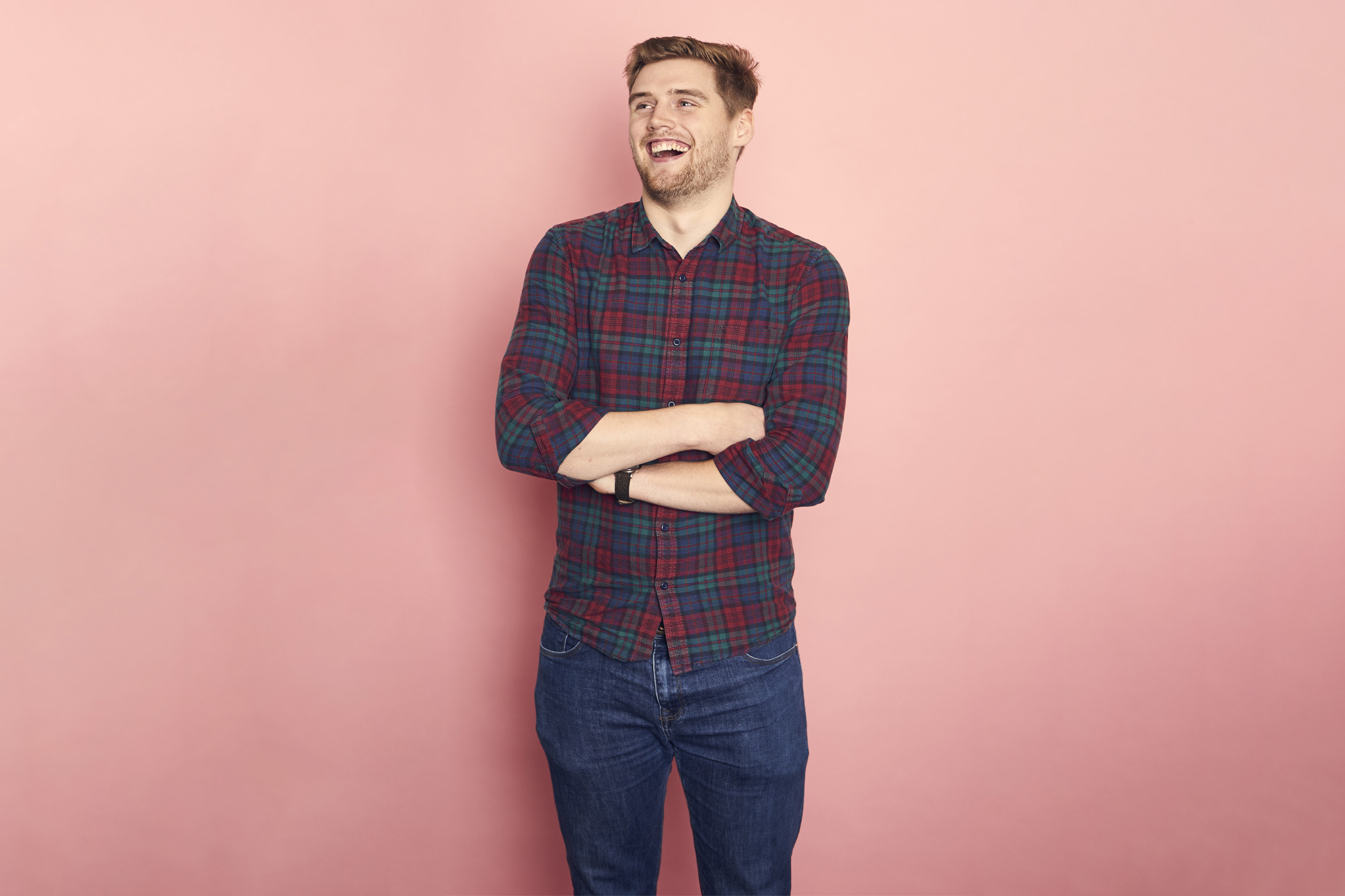 An Abertay Student on a pink coloured background