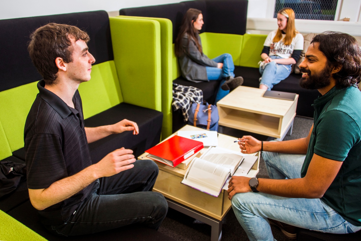 Students chatting in a social space on the Abertay campus.
