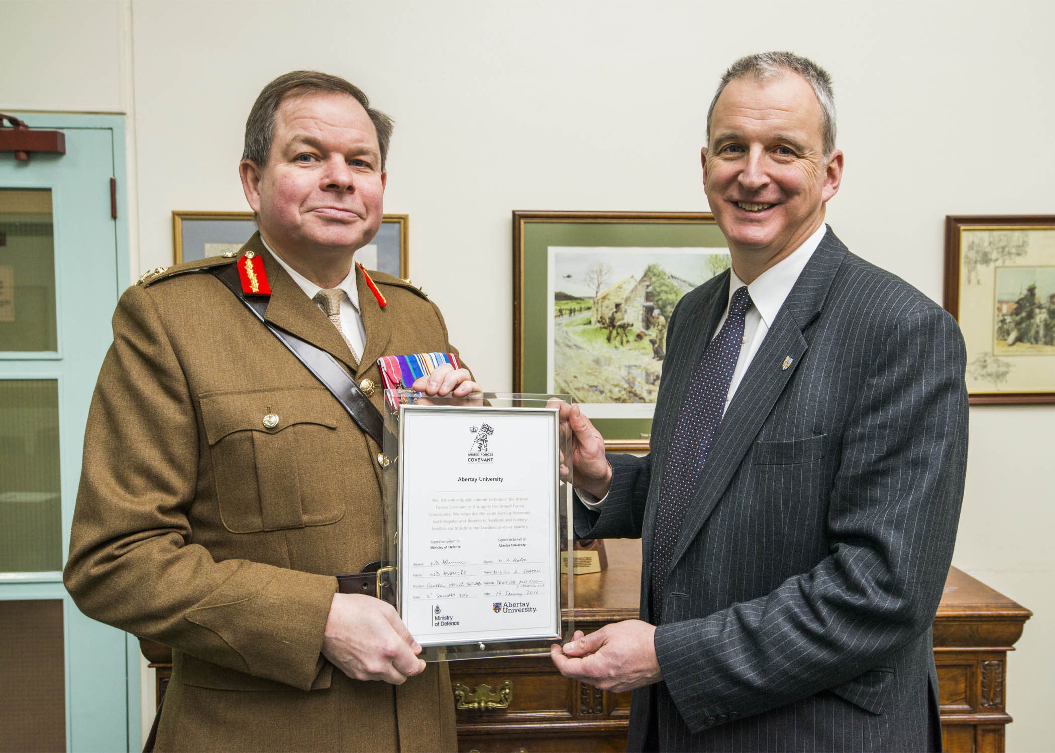 Nigel Seaton and Major General Nick Ashmore holding Signed Armed Forces Covenant Final